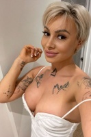 A very sexy blonde escort with great tattoos